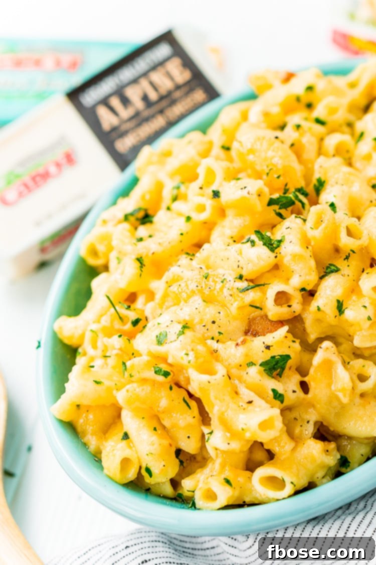This Crock Pot Mac and Cheese is an easy and delicious dinner loaded with cheddar and Colby Jack cheeses and perfect for a weeknight meal or cozy weekend dinner!
