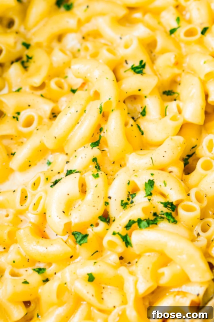 This Crock Pot Mac and Cheese is an easy and delicious dinner loaded with cheddar and Colby Jack cheeses and perfect for a weeknight meal or cozy weekend dinner!