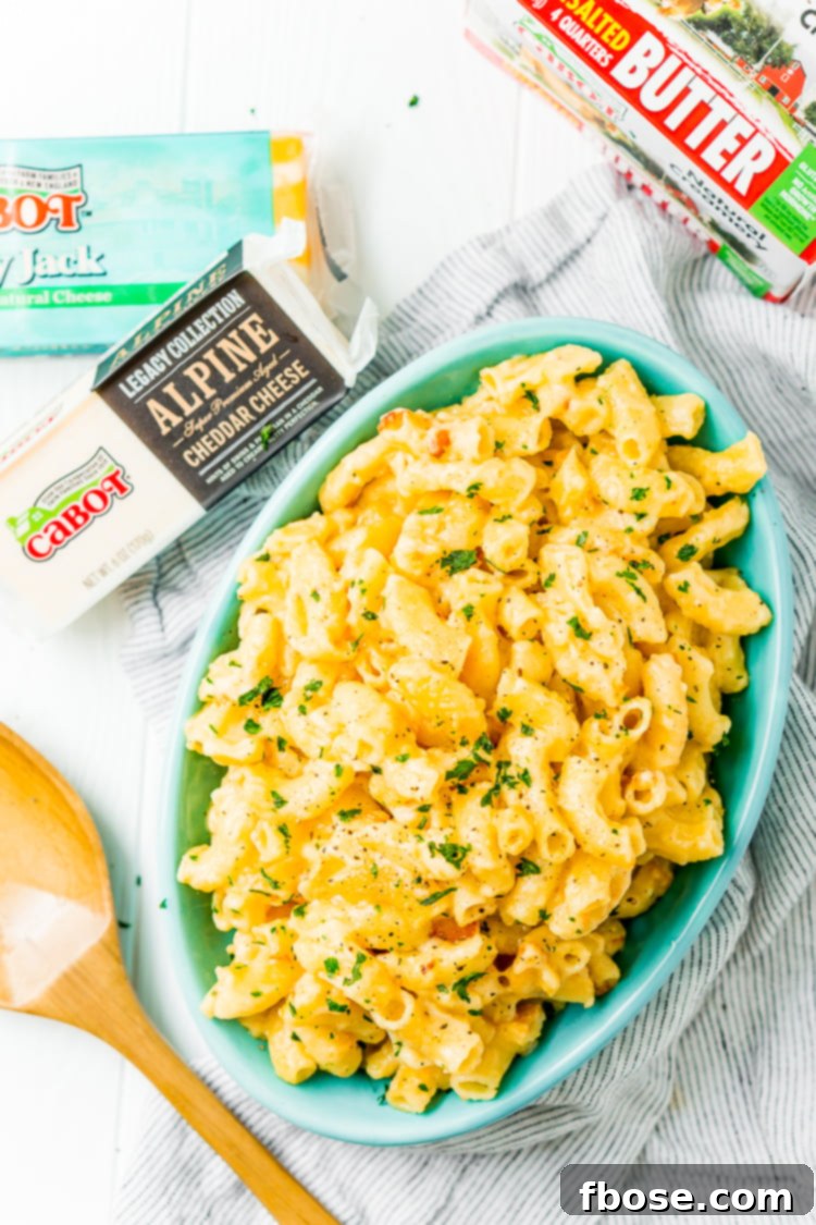 This Crock Pot Mac and Cheese is an easy and delicious dinner loaded with cheddar and Colby Jack cheeses and perfect for a weeknight meal or cozy weekend dinner!