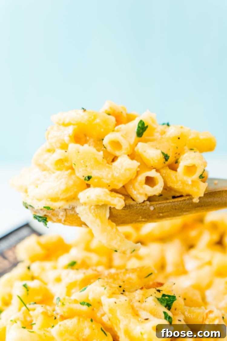 This Crock Pot Mac and Cheese is an easy and delicious dinner loaded with cheddar and Colby Jack cheeses and perfect for a weeknight meal or cozy weekend dinner!
