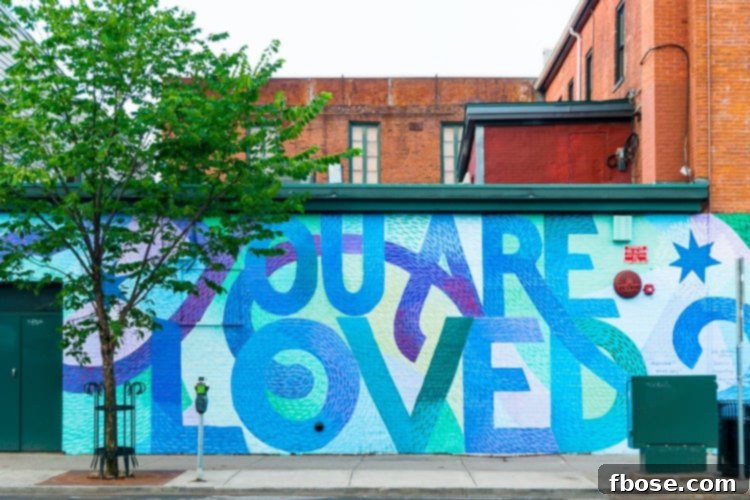Unlocking Burlington: Essential Experiences in Vermont 14 A vibrant mural on a building wall in Burlington, Vermont, clearly stating "You Are Loved," symbolizing the city