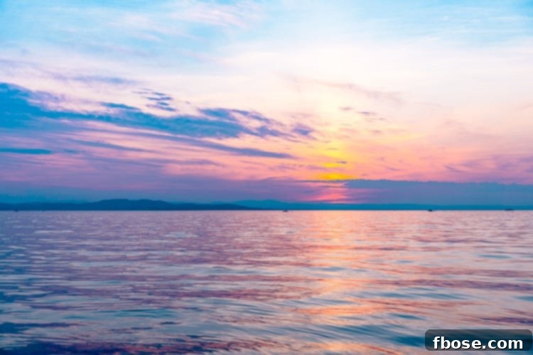 Unlocking Burlington: Essential Experiences in Vermont 16 A stunning seascape of a sunset over Lake Champlain, with vibrant colors reflecting on the calm water, a must-see in Burlington, Vermont.