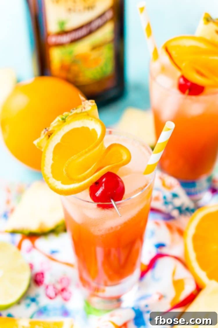 Planter's Punch: A Caribbean Classic 3 A single glass of Planter's Punch, garnished with a vibrant maraschino cherry, a fresh orange slice, and a pineapple wedge, showcasing its appealing tropical presentation.