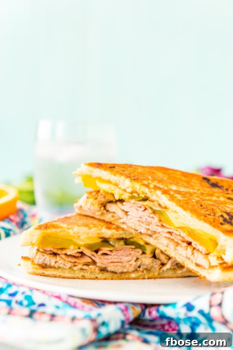 The Ultimate Cuban Sandwich: A Taste of Sunshine in Every Bite! This Cuban Sandwich is loaded with smoked ham, swiss cheese, mojo pork, mustard, and pickles, and then grilled to melty perfection!