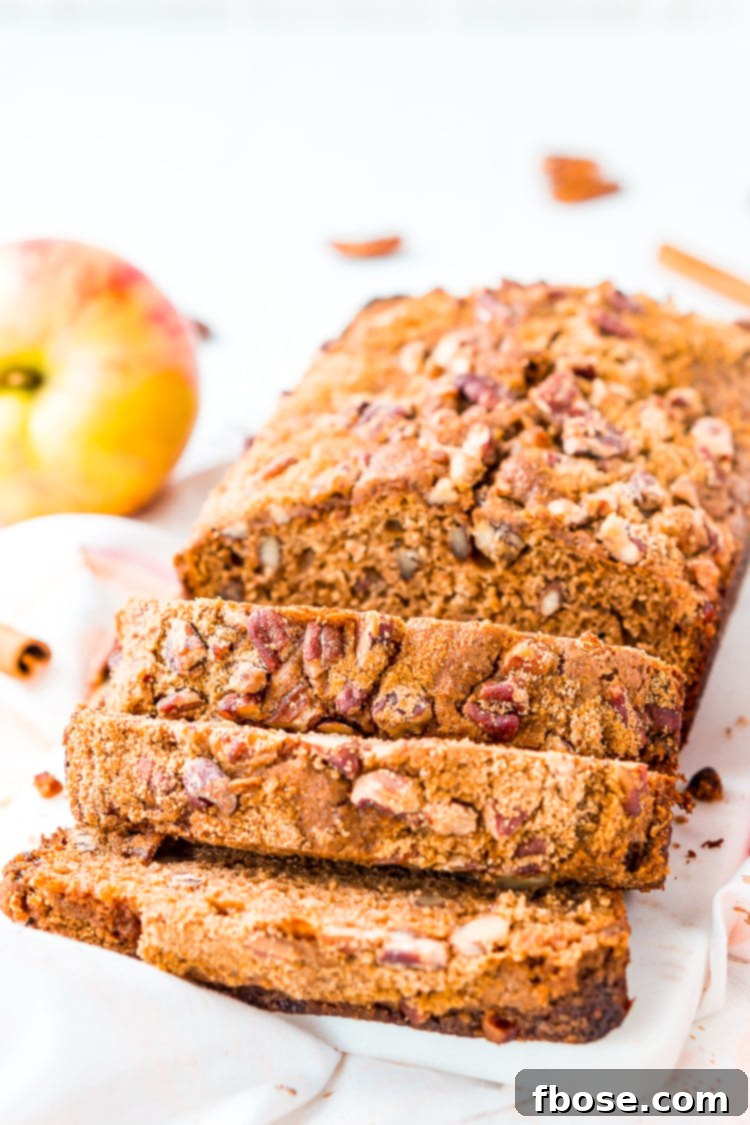 Freshly baked Applesauce Bread, cooling on a wire rack, ready to be sliced and enjoyed during the autumn festivities.