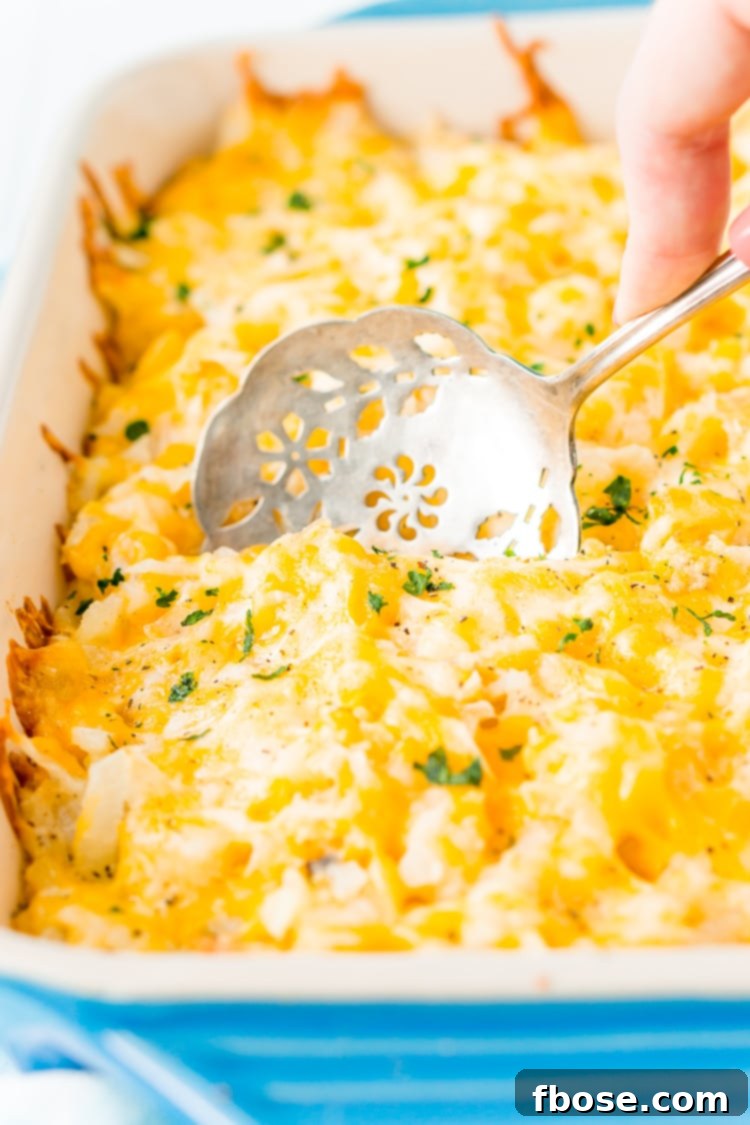 Freshly baked Hashbrown Casserole, topped with bubbling melted cheese, straight out of the oven.