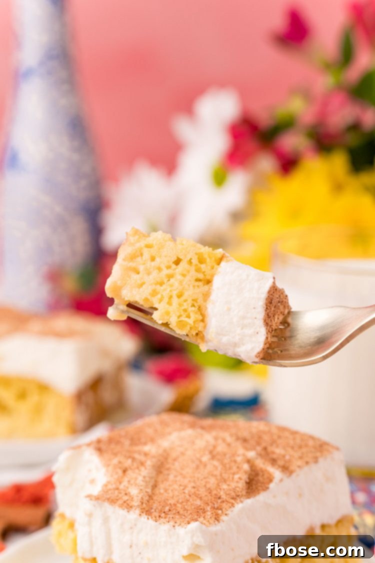 Tres Leches Cake 6 A fork with a bite of tres leches cake on it, ready to be enjoyed.