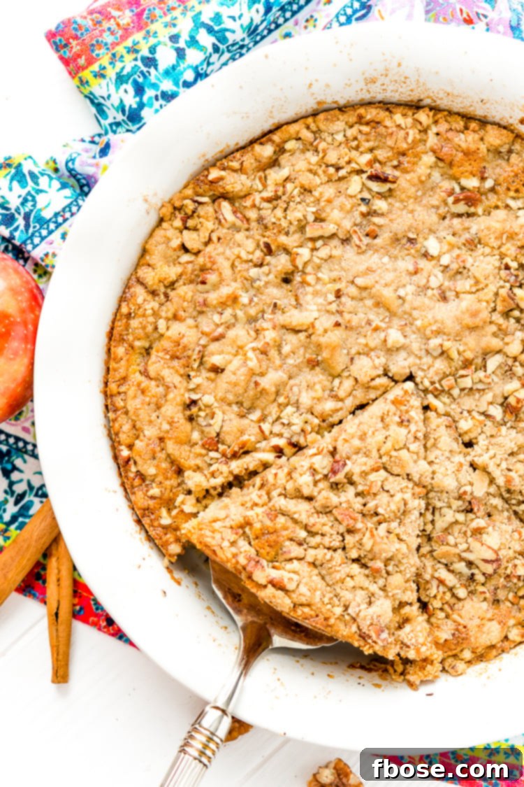 A baked Impossible French Apple Pie, fresh out of the oven, with a perfectly browned topping.