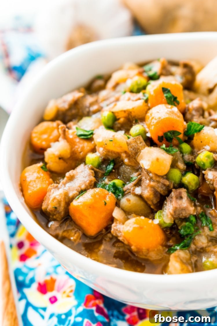 Tender Slow-Cooked Beef Stew 2 A steaming bowl of Crock Pot Beef Stew, rich with tender beef, carrots, peas, and potatoes, perfect for chilly weather.