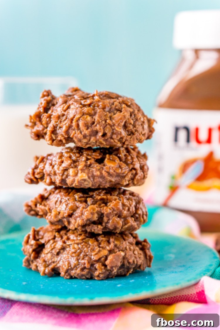 A close-up of a batch of fresh Nutella No Bake Cookies, featuring the distinct swirl of chocolate and hazelnut, and the inviting texture of oats.