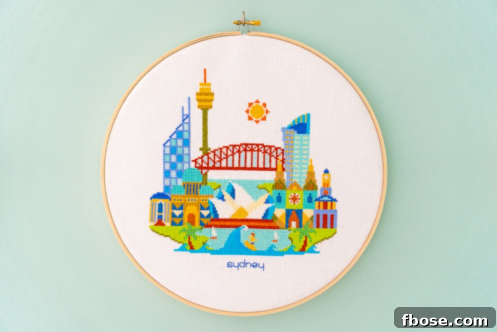 Detailed Sydney cross-stitch hoop art, featuring the iconic Opera House and Harbor Bridge, adding a unique global touch to the nursery.
