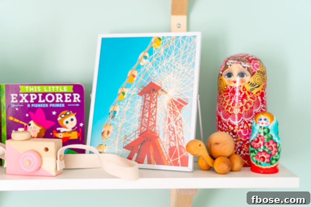A thoughtfully curated shelf in a baby nursery, featuring travel-inspired decor like a framed photo, a turtle toy, and nesting dolls, creating a global aesthetic.