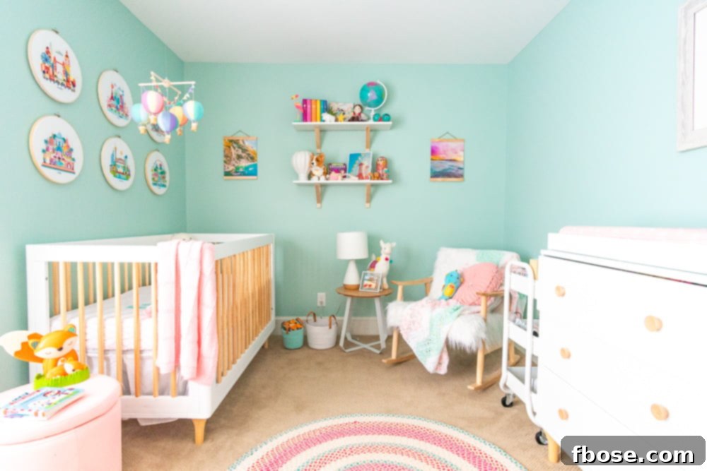 Two framed travel photos hanging in a baby girl's nursery, showcasing global beauty with wooden magnetic frames.