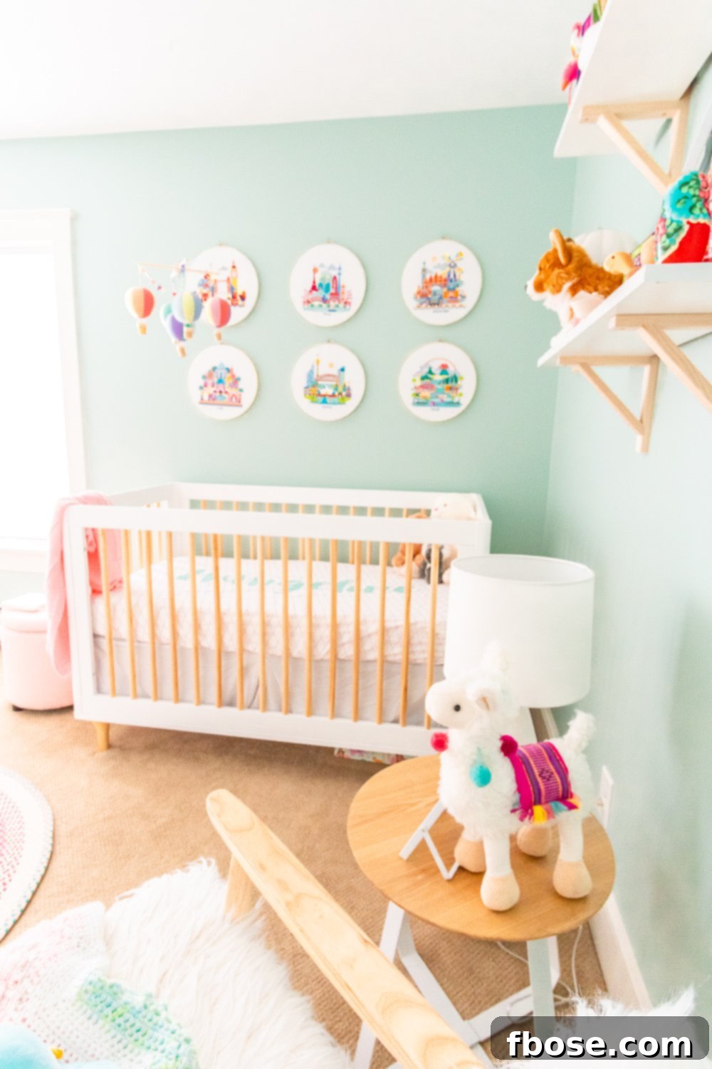 A modern crib and shelves adorned with soft stuffed animals in a peaceful travel-themed nursery.