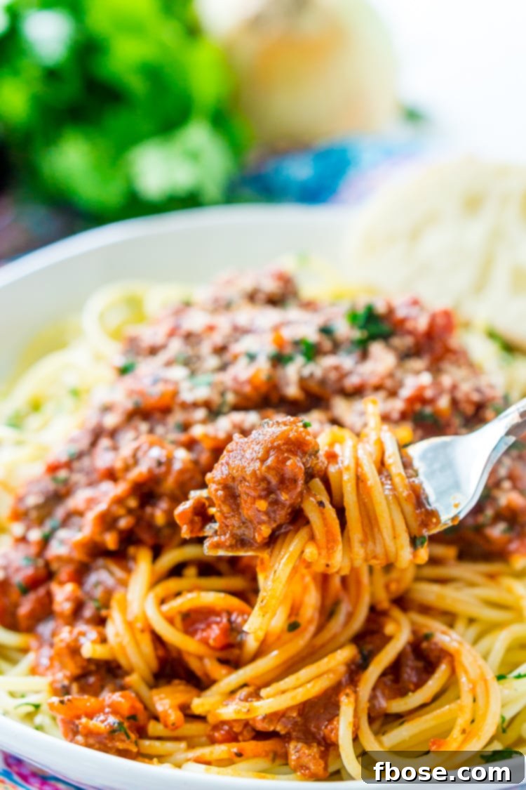Overhead view of a prepared dish of spaghetti bolognese in a serving bowl.