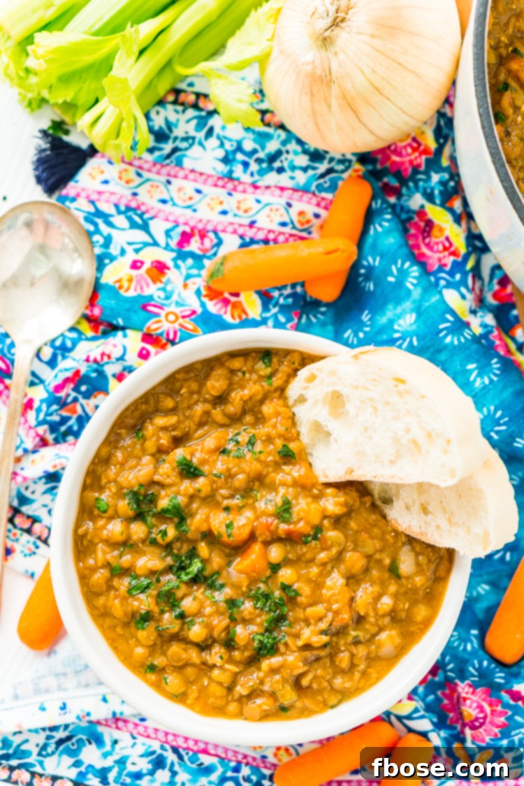 Several bowls of lentil soup arranged on a rustic wooden table, ready to be enjoyed.