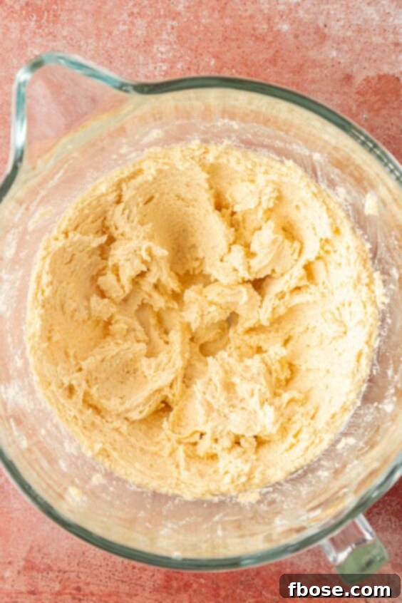Cookie dough being creamed in a bowl.
