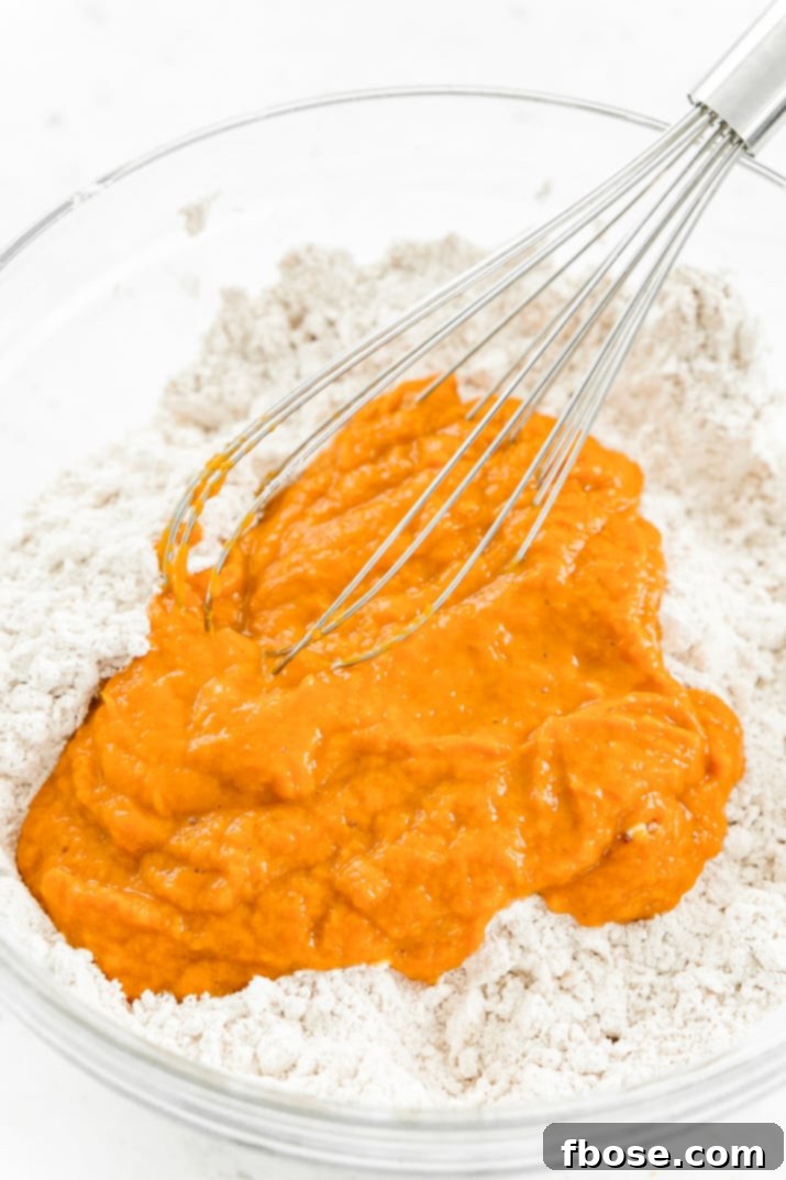 Step-by-step guide to making Pumpkin Scones: whisking dry ingredients and cutting in cold butter for a flaky texture.