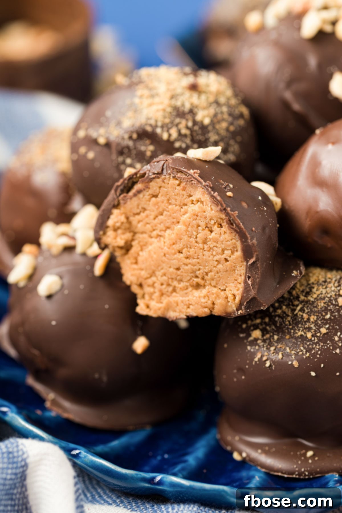 Chilled Peanut Butter Bliss Balls 2 Chocolate dipped peanut butter balls on a blue plate.