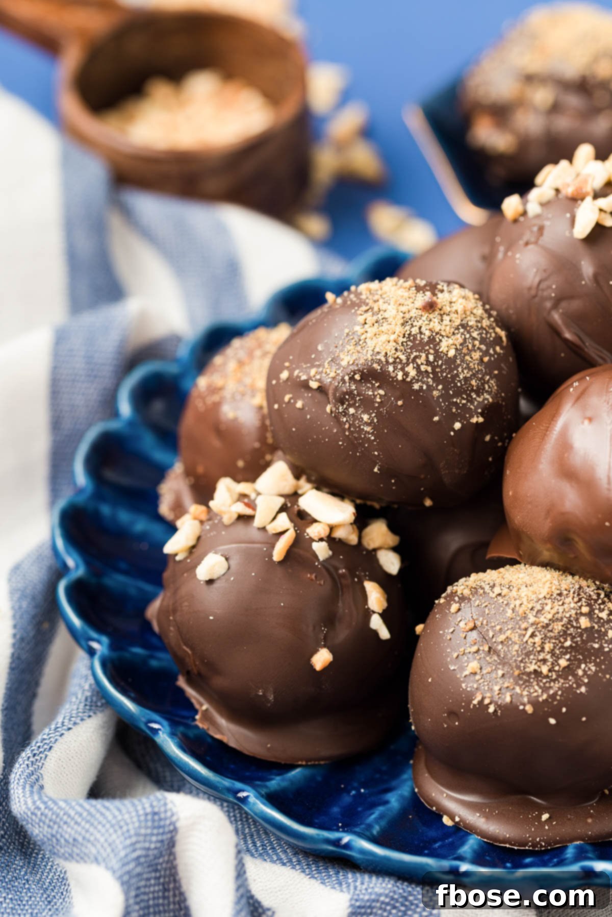 Chilled Peanut Butter Bliss Balls 6 Peanut butter balls on a blue plate.