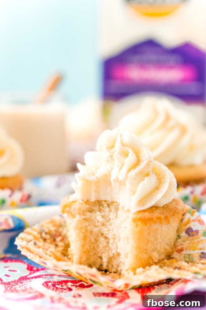 Spiced Chai Cupcakes 7 A selection of delicious Chai Cupcakes with Vanilla Frosting, arranged on a rustic wooden board. These warm-spiced treats are perfect for sharing or a personal moment of comfort.