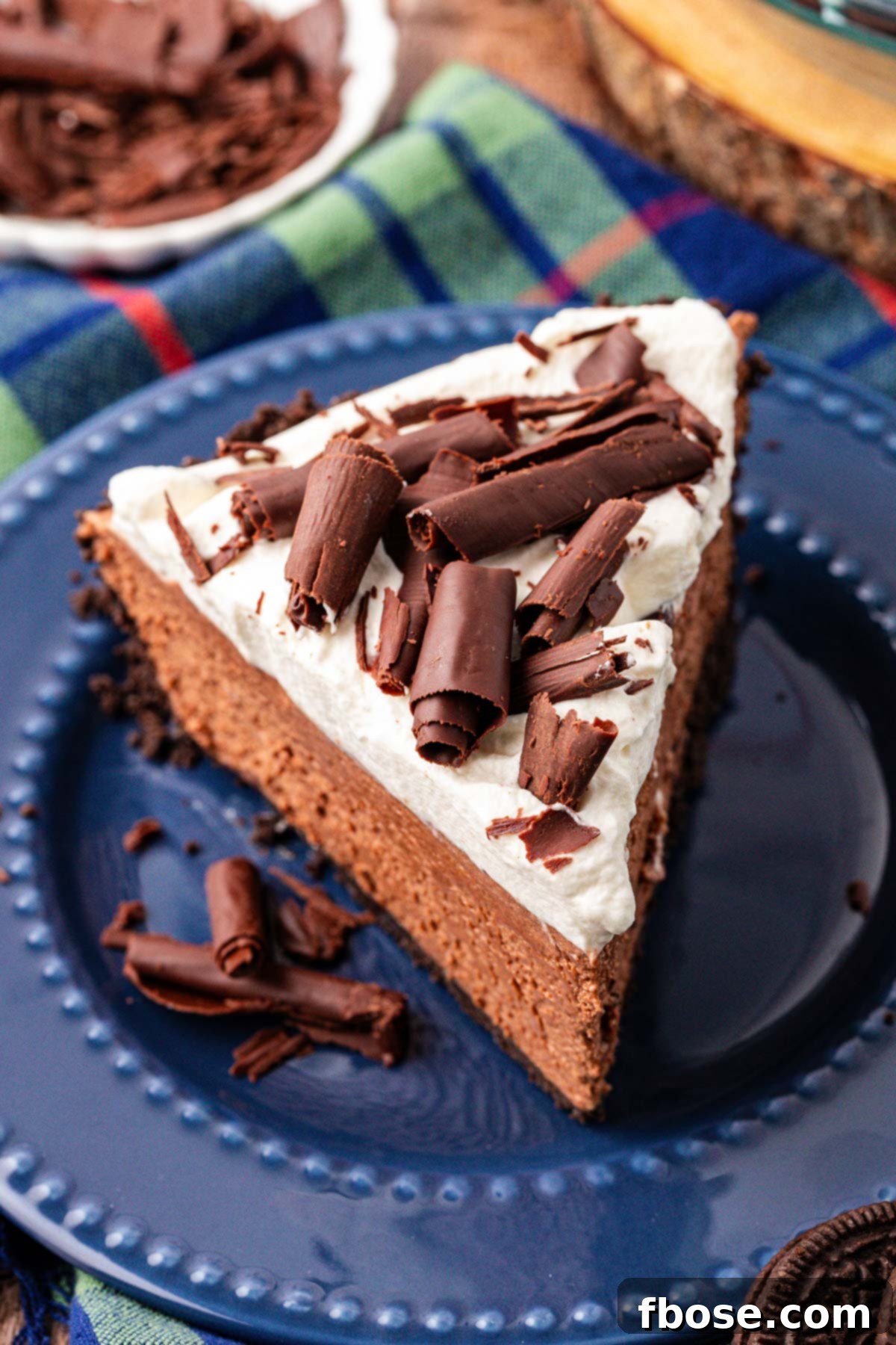 A slice of chocolate french silk pie on a blue plate, ready to be enjoyed.