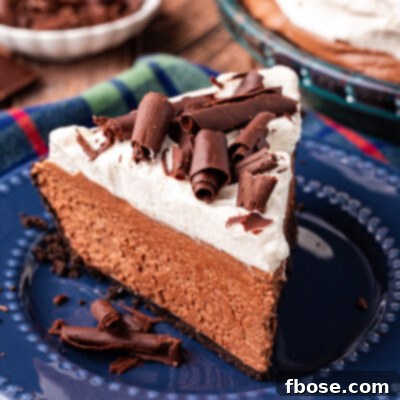 A slice of chocolate french silk pie on a blue plate.