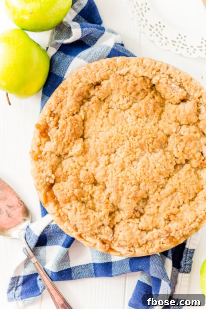 Old World Dutch Apple Pie 4 An overhead view of a golden Dutch Apple Pie, with a serving spatula placed beside it, hinting at its deliciousness.