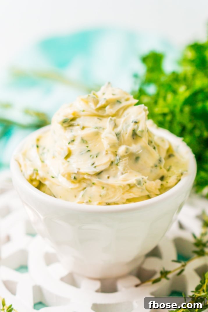 This savory Herb Butter is infused with parsley, thyme, rosemary, black pepper, and lemon zest for a flavorful spread that tastes delicious on garlic bread, dinner rolls, steak, and more!