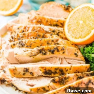 Sliced turkey breast on a white plate.