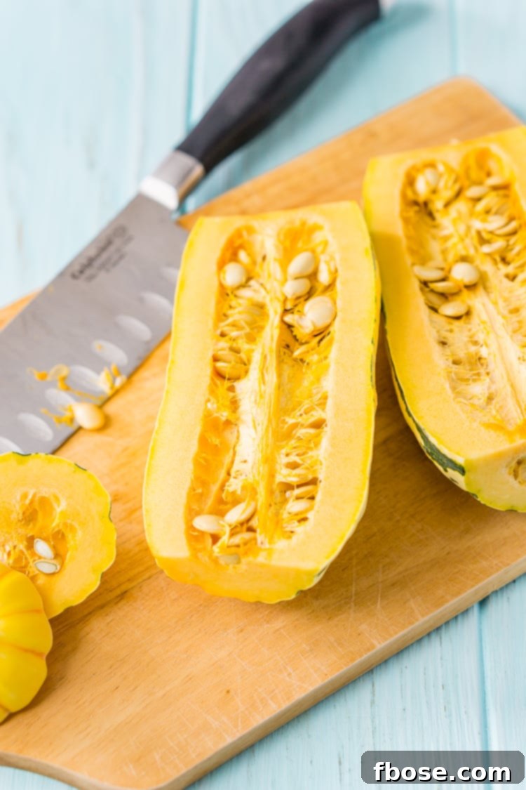 Sweet Roasted Delicata Squash 5 Delicata squash being cut lengthwise on a cutting board.