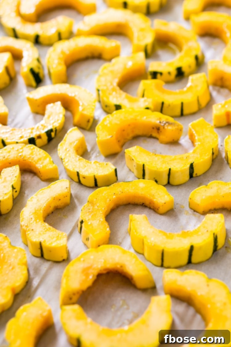 Sweet Roasted Delicata Squash 8 Perfectly roasted delicata squash slices on a baking sheet.