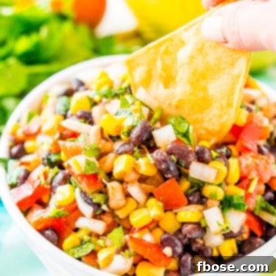 Cowboy Caviar, a Mexican-inspired dip loaded with beans, corn, onion, peppers, tomato, cilantro, and zesty spices.