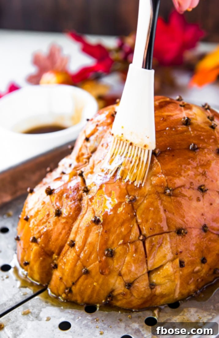 Close-up of a glazed ham, highlighting the beautiful texture and color of the maple ham glaze.