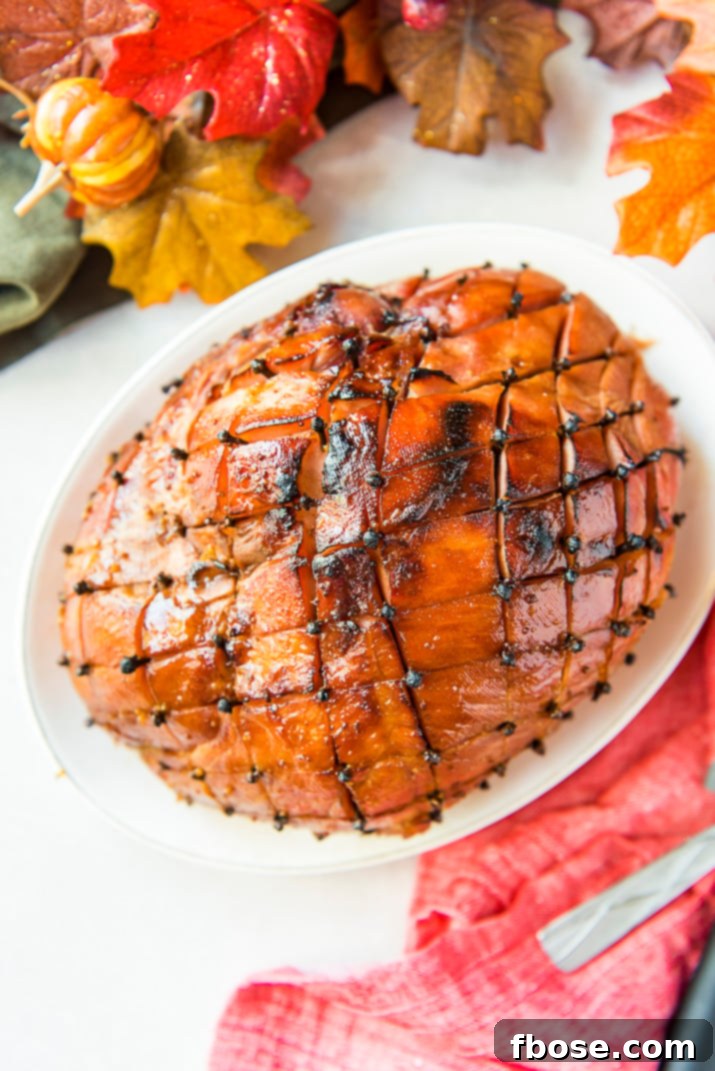 A vibrant close-up of the Maple Ham Glaze bubbling in a saucepan, highlighting its rich texture and color.