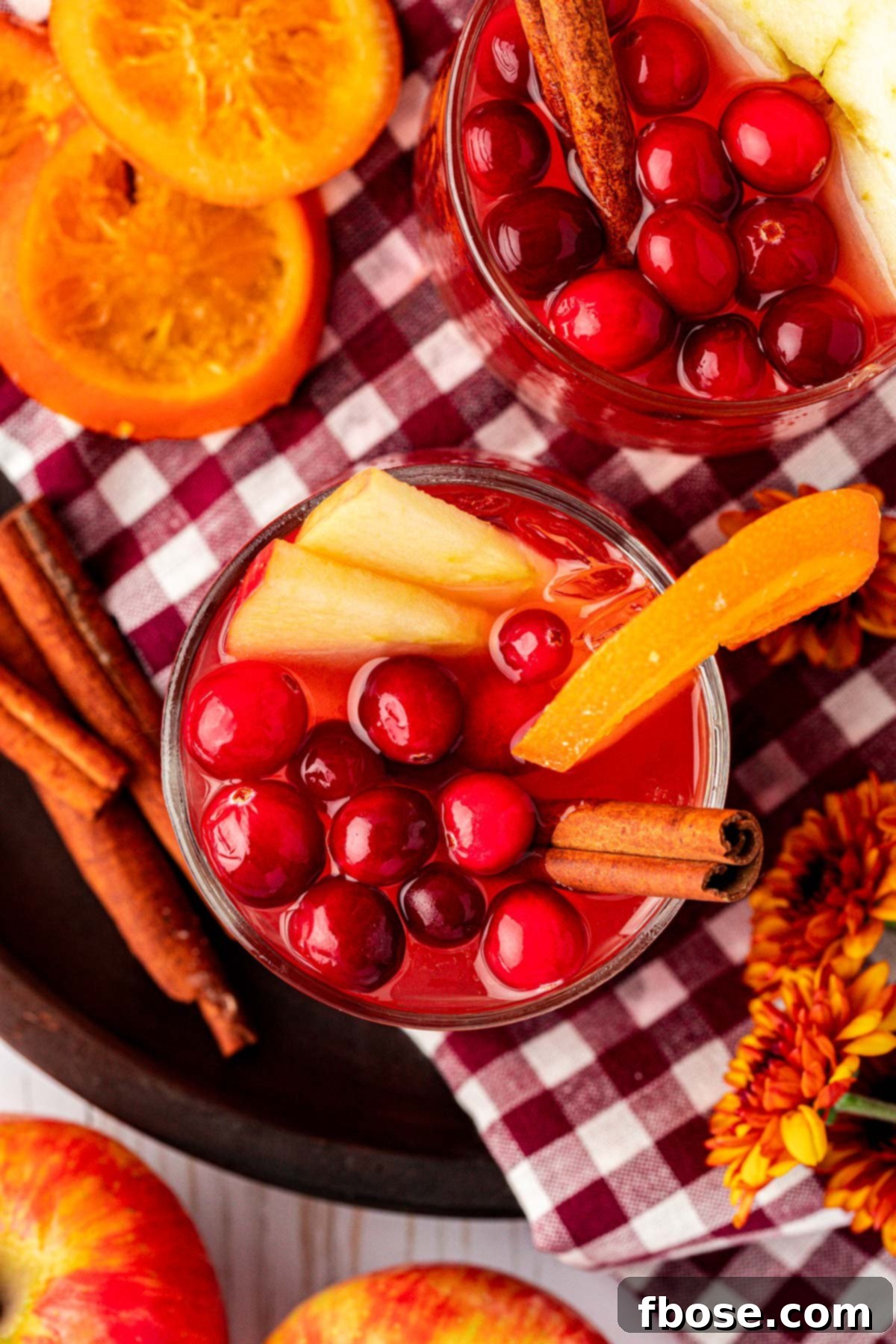 Overhead photo of two glasses of red punch for Thanksgiving.