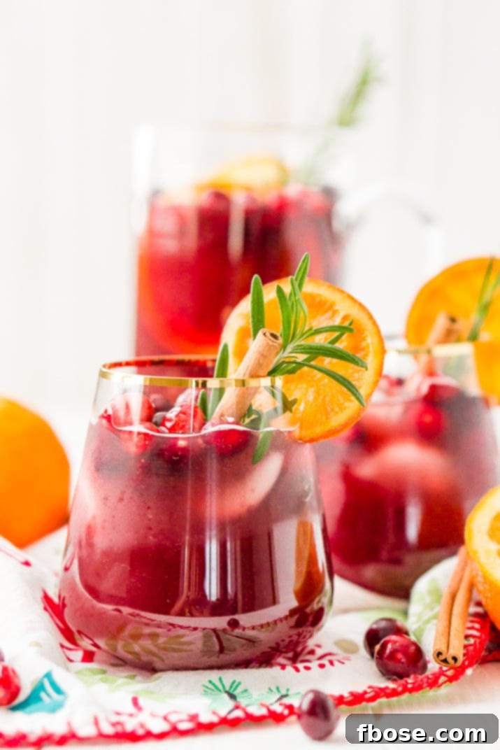 This Christmas Sangria is made with red wine, fruit juices, brandy, soda, and fruit for a delicious big-batch cocktail that's perfect for parties.