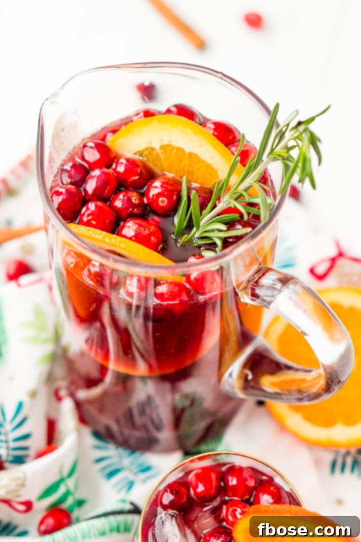 This Christmas Sangria is made with red wine, fruit juices, brandy, soda, and fruit for a delicious big-batch cocktail that's perfect for parties.