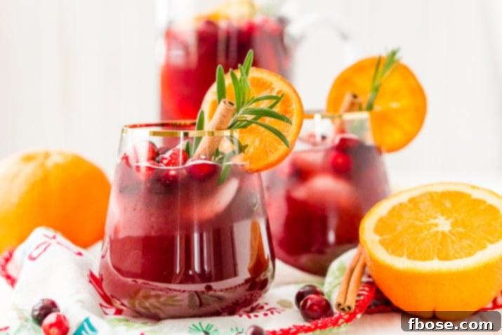 This Christmas Sangria is made with red wine, fruit juices, brandy, soda, and fruit for a delicious big-batch cocktail that's perfect for parties.