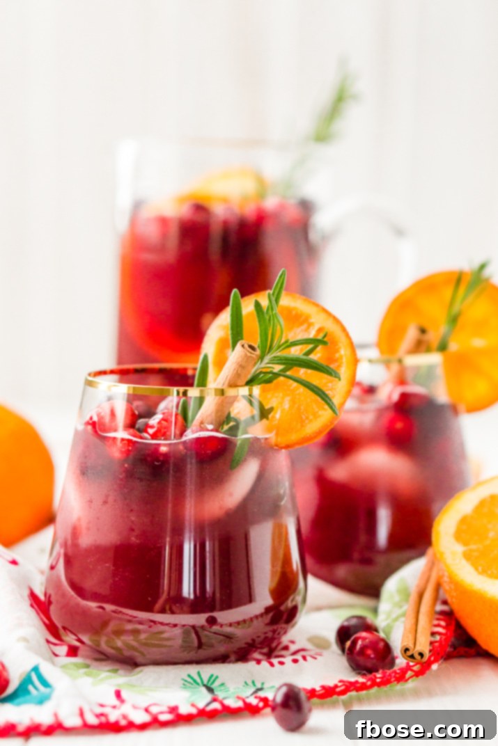 This Christmas Sangria is made with red wine, fruit juices, brandy, soda, and fruit for a delicious big-batch cocktail that's perfect for parties.