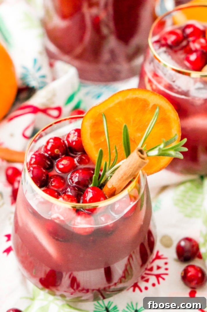 This Christmas Sangria is made with red wine, fruit juices, brandy, soda, and fruit for a delicious big-batch cocktail that's perfect for parties.