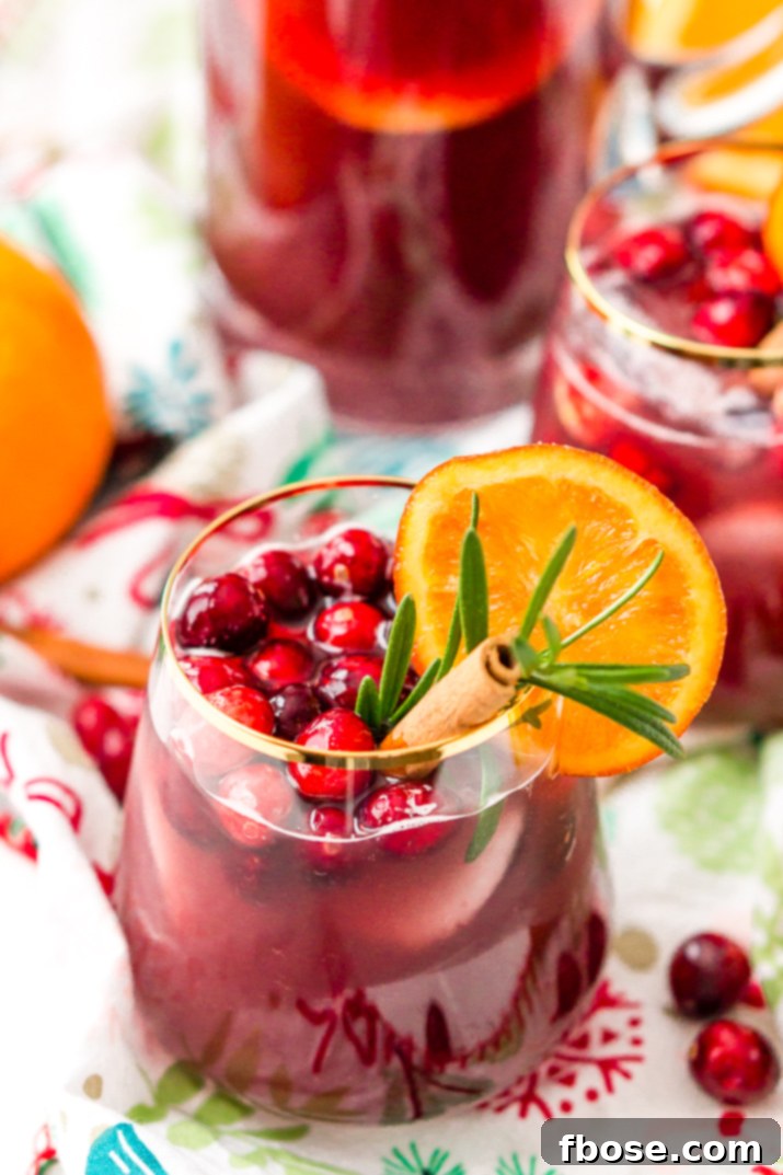 This Christmas Sangria is made with red wine, fruit juices, brandy, soda, and fruit for a delicious big-batch cocktail that's perfect for parties.