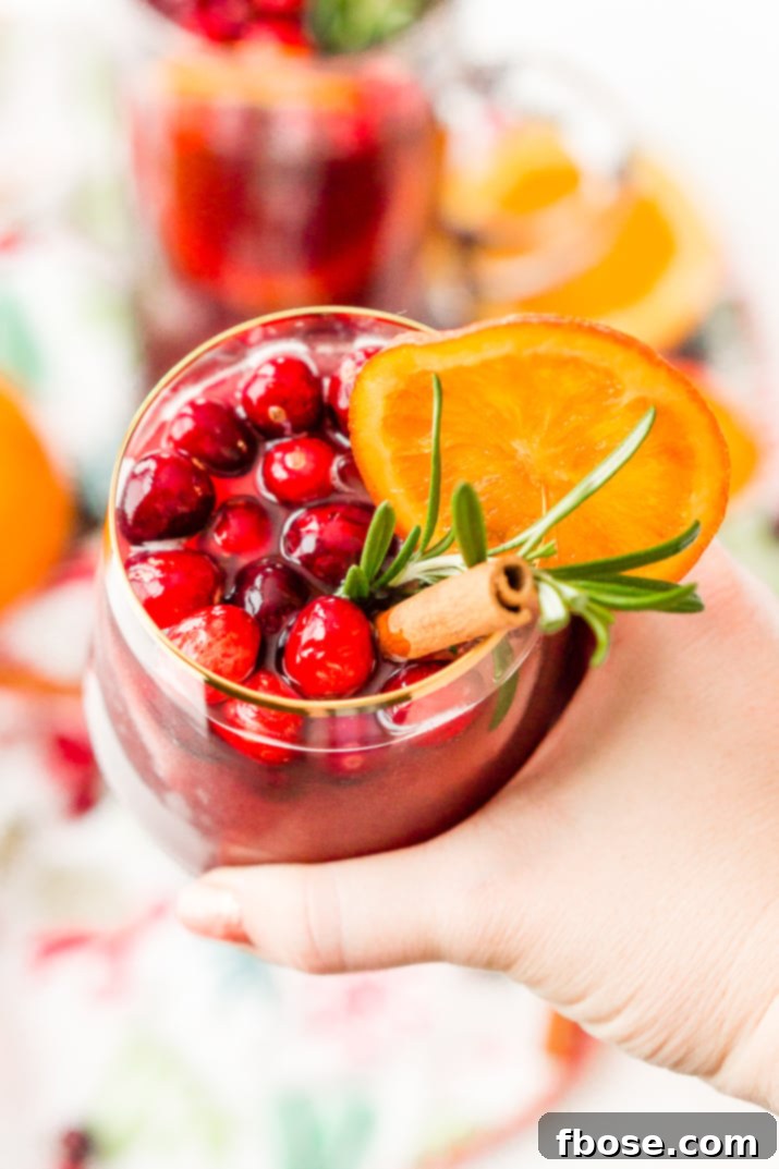 This Christmas Sangria is made with red wine, fruit juices, brandy, soda, and fruit for a delicious big-batch cocktail that's perfect for parties.
