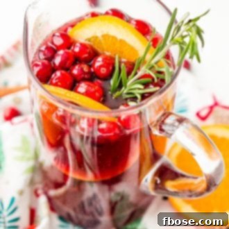 This Christmas Sangria is made with red wine, fruit juices, brandy, soda, and fruit for a delicious big-batch cocktail that's perfect for parties.