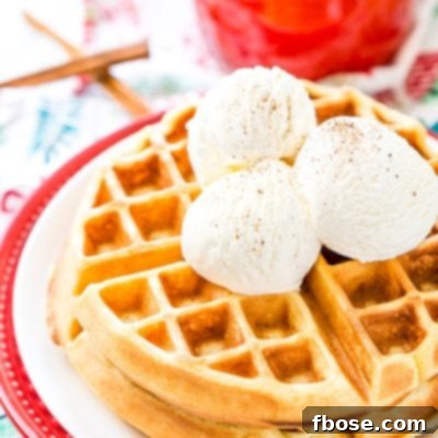 Eggnog Waffles are crisp and golden on the outside and fluffy on the inside, topped with whipped cream and spiced vanilla syrup!