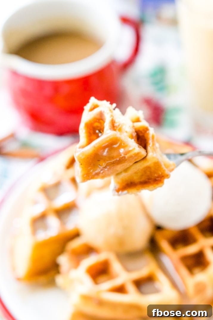 A charming close-up of Spiced Vanilla Syrup served in a small pitcher next to a stack of golden waffles, garnished with fresh berries, highlighting a delightful breakfast scene.