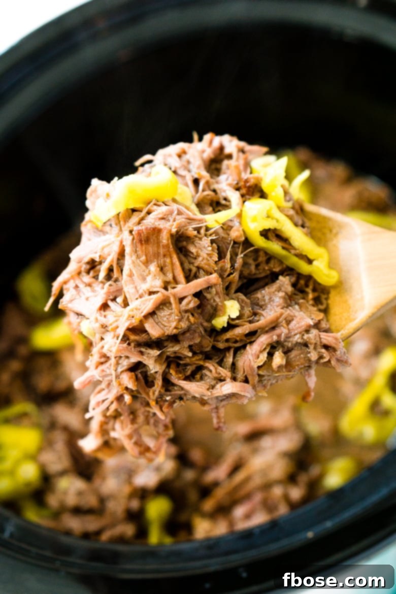 Italian Beef being scooped out of crock pot