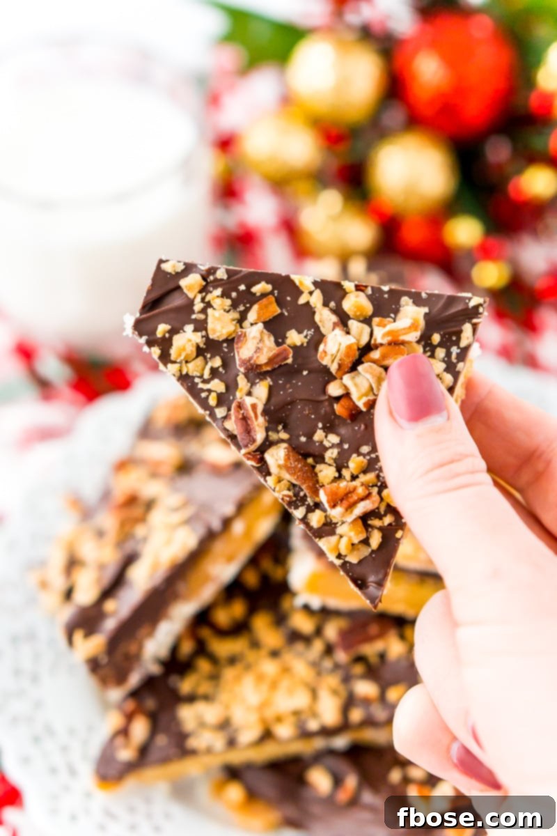 Woman's hand holding a piece of Christmas crack