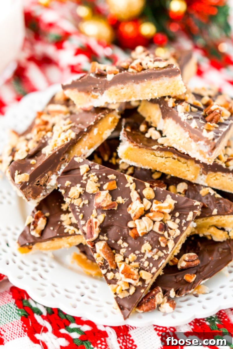 Shortbread Christmas Crack on white plate with holiday decorations