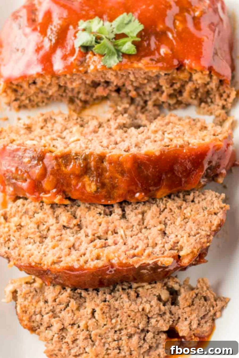 A close-up of a meatloaf slice showing its moist and tender texture, ready to be served.